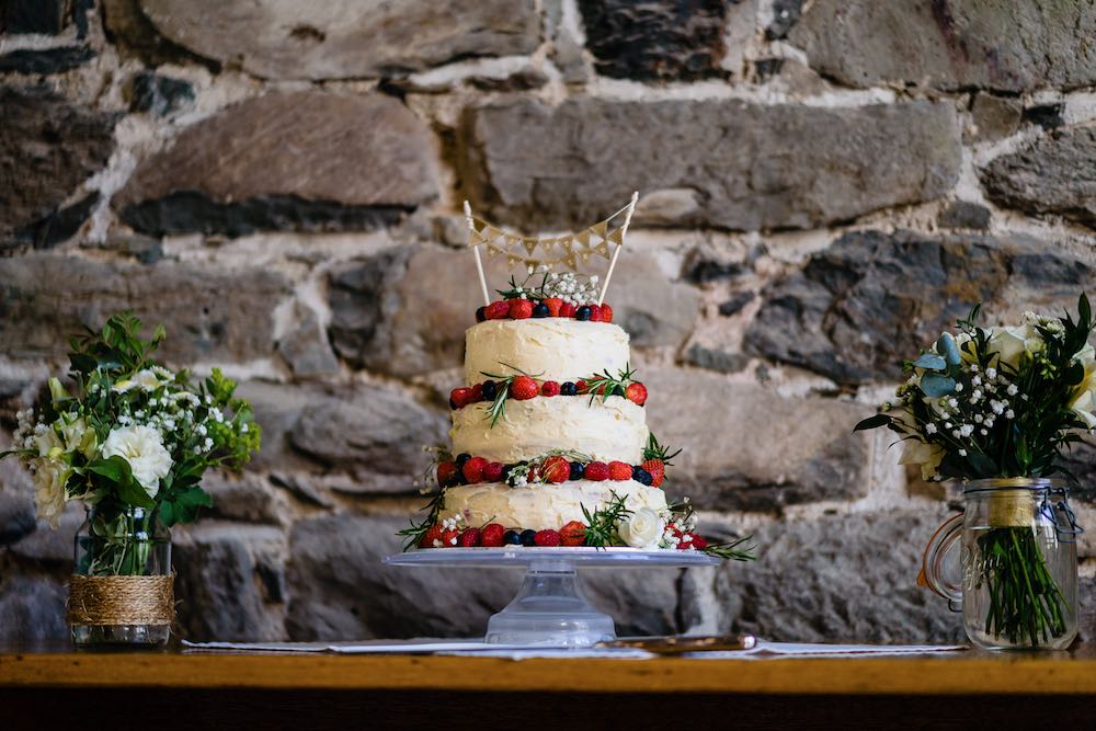 Cris Lowis photo of wedding cake on our oak trestle table in Big barn